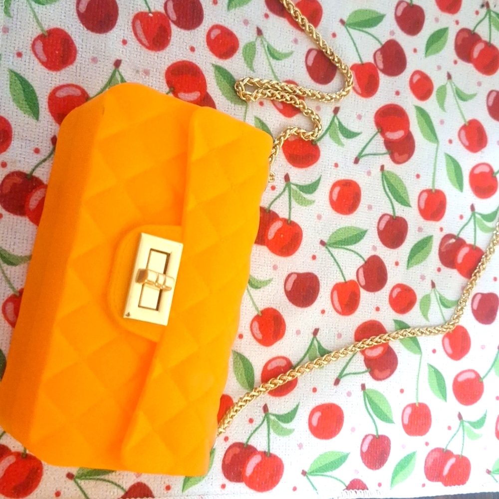 Orange plastic purse with gold strap